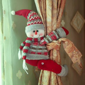Snowman curtain tieback with red hat, scarf, and plaid sweater, holding back gold curtains.