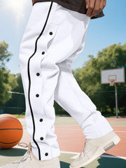 White track pants with black snap buttons and side stripe detail.