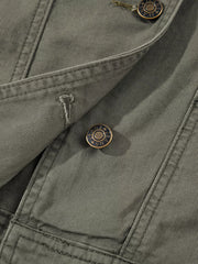 Ruffled denim vest in olive green with button closure and branded buttons.