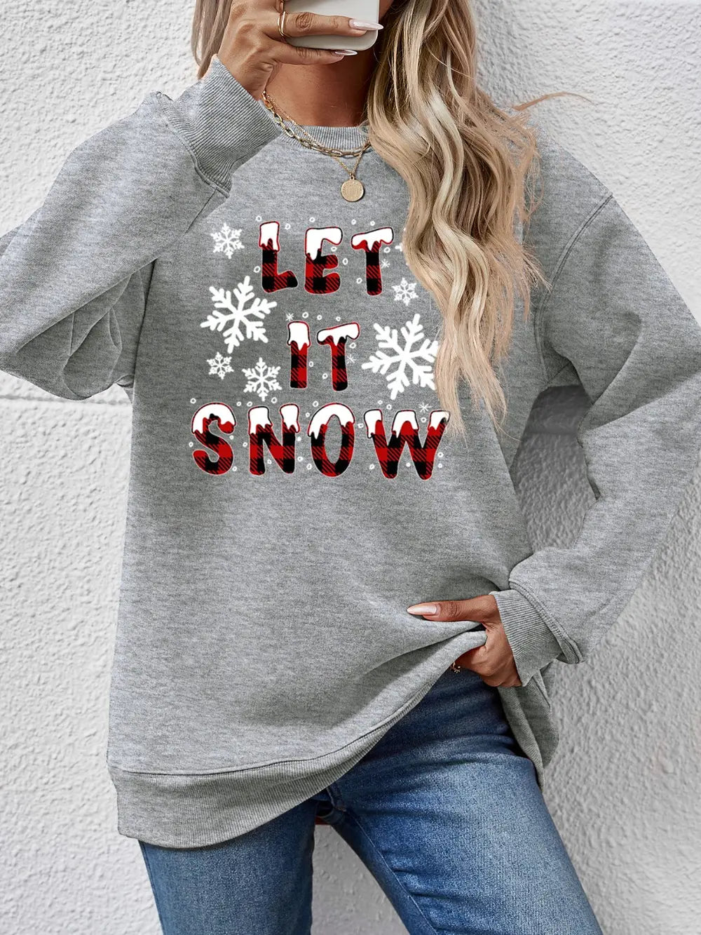Gray crewneck sweatshirt with "Let It Snow" graphic and snowflakes