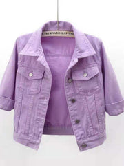 Lavender denim trucker jacket with cropped sleeves and button pockets.