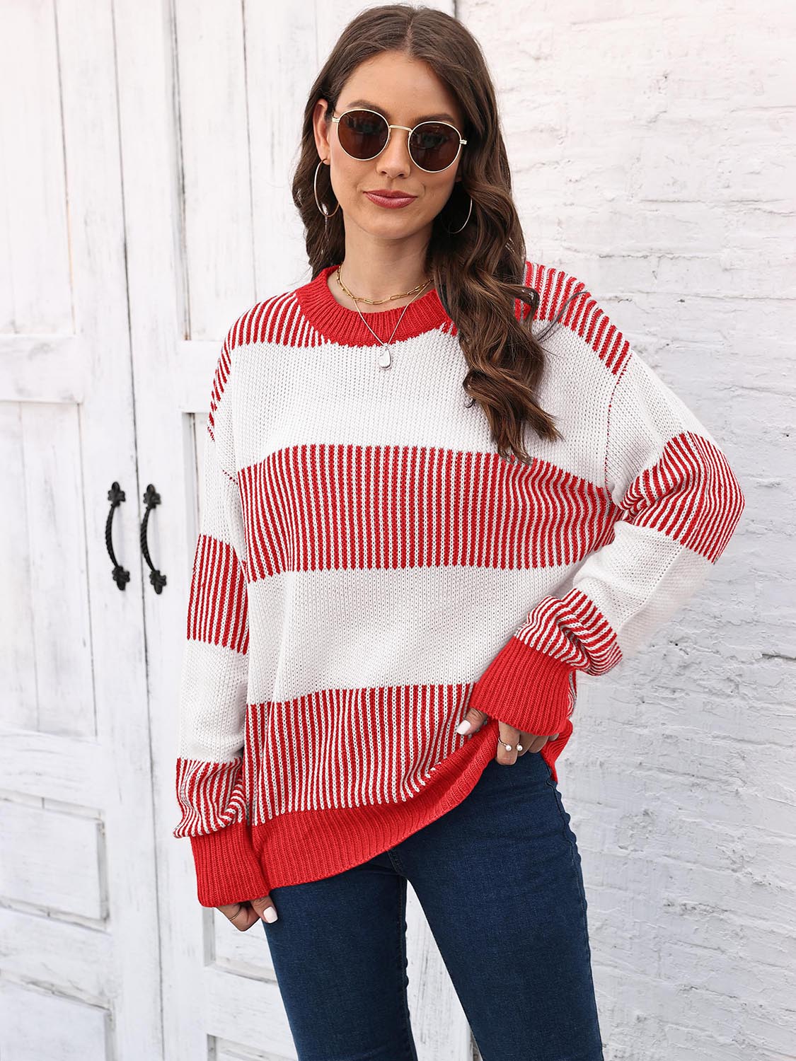 Striped knit crewneck sweater in red and white with ribbed trim.