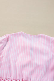 Blush pink striped peplum blouse with puff sleeves and ruffled hem detail.