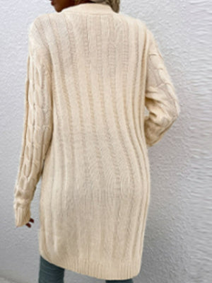 Tan cable knit button-down cardigan with textured pattern.