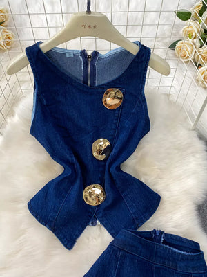 Dark blue cotton denim vest with asymmetrical gold buttons and zipper detail.