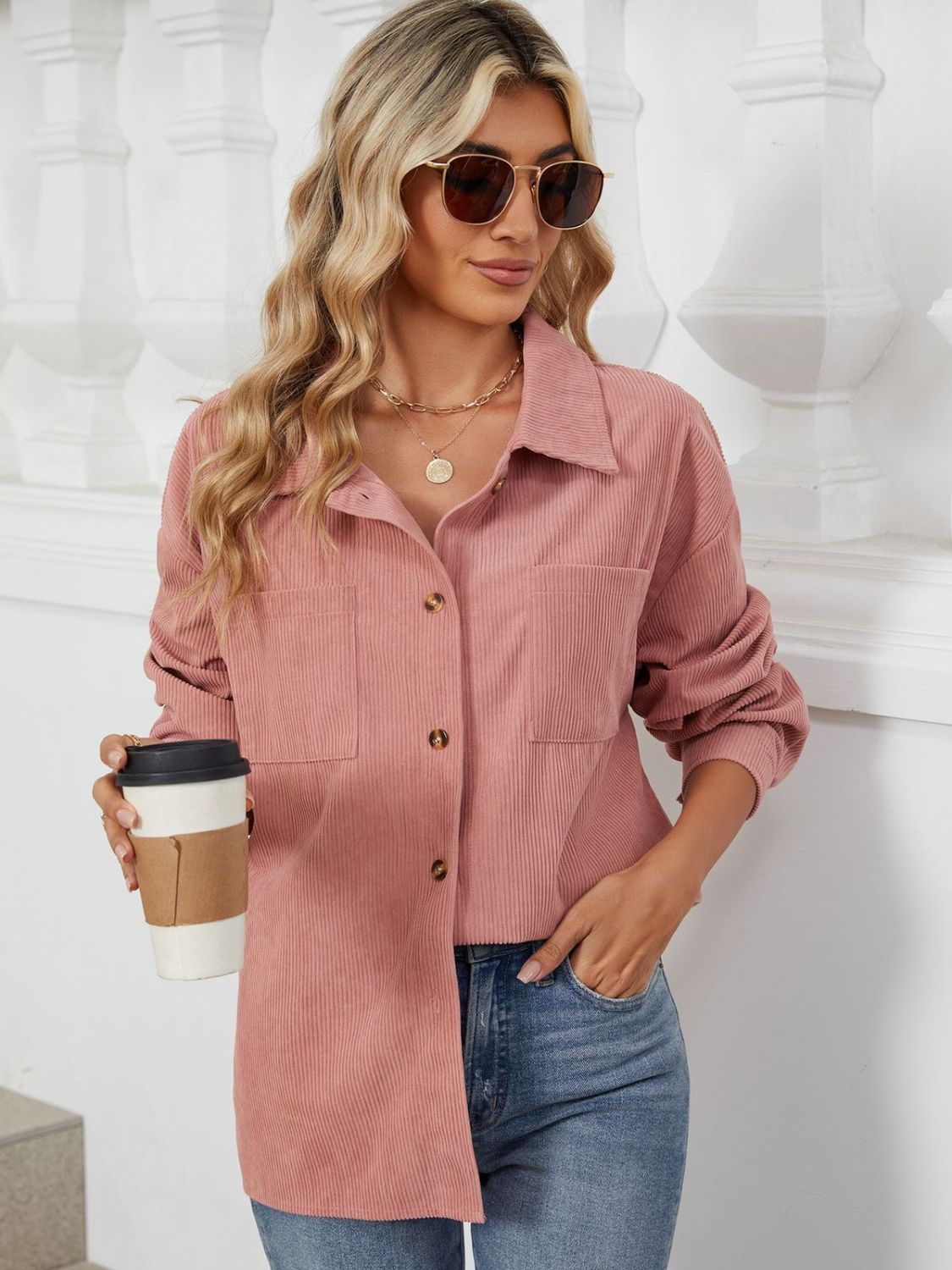 Pink corduroy overshirt with buttoned patch pockets and a collared neckline.