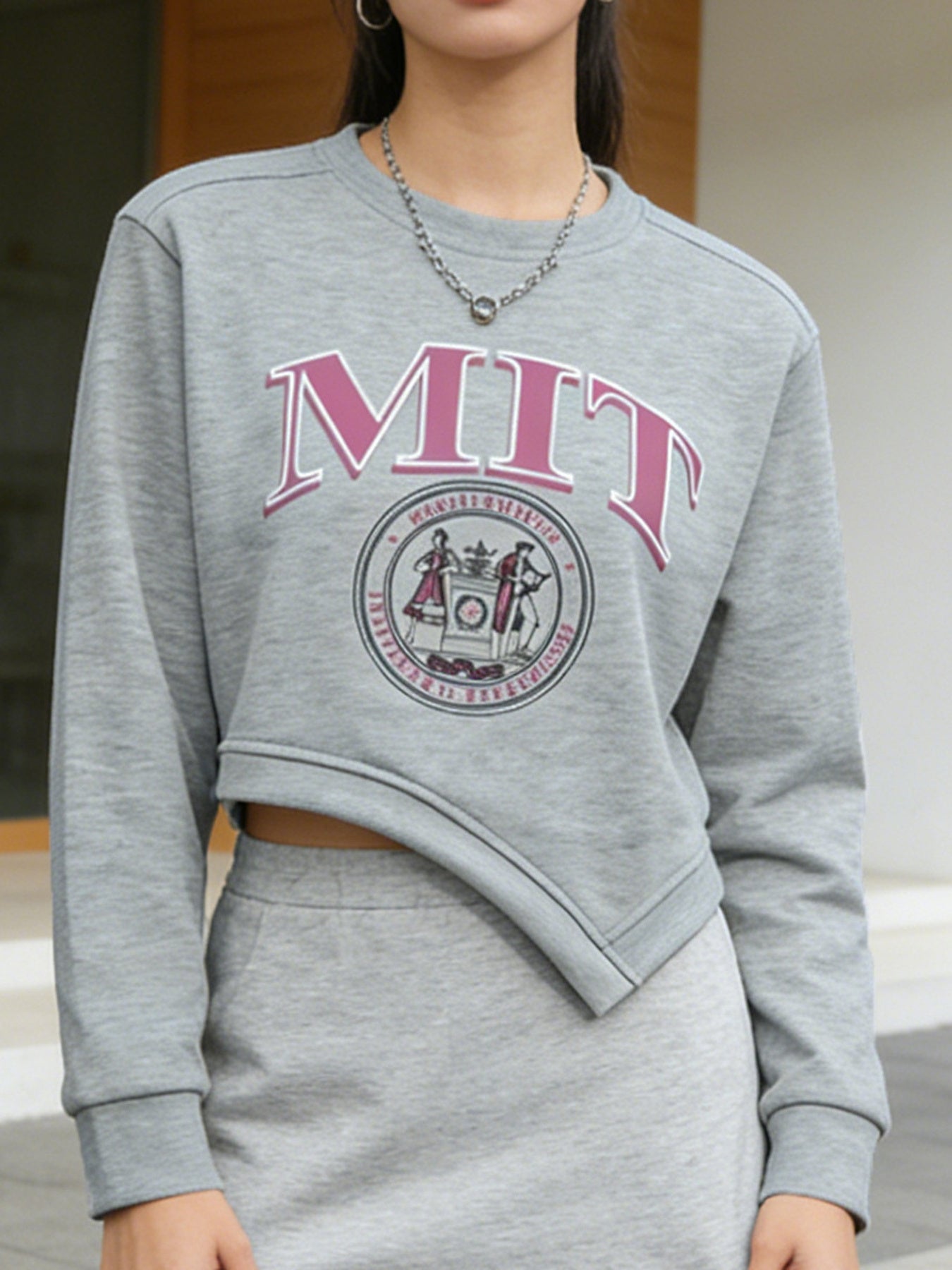 Grey asymmetrical cropped sweatshirt with MIT graphic and crew neck.