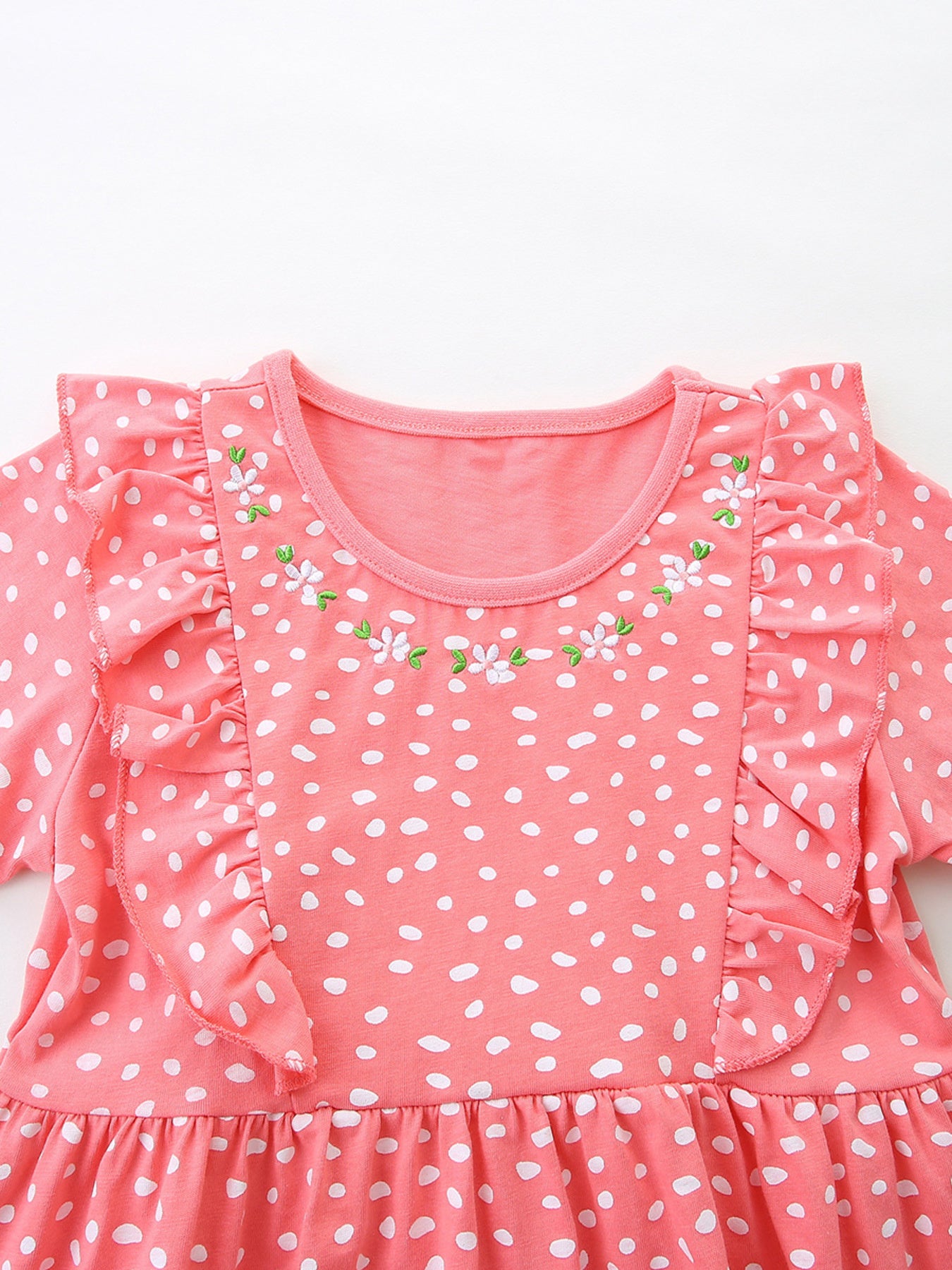 Coral polka dot cotton dress with ruffled sleeves and floral embroidery detail.