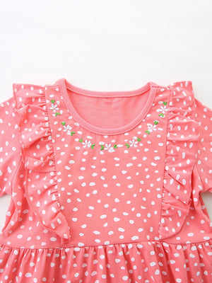 Coral polka dot cotton dress with ruffled sleeves and floral embroidery detail.