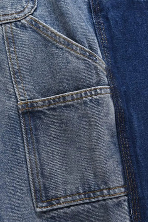Panelled denim carpenter shorts in dark and medium blue washes with contrast stitching.