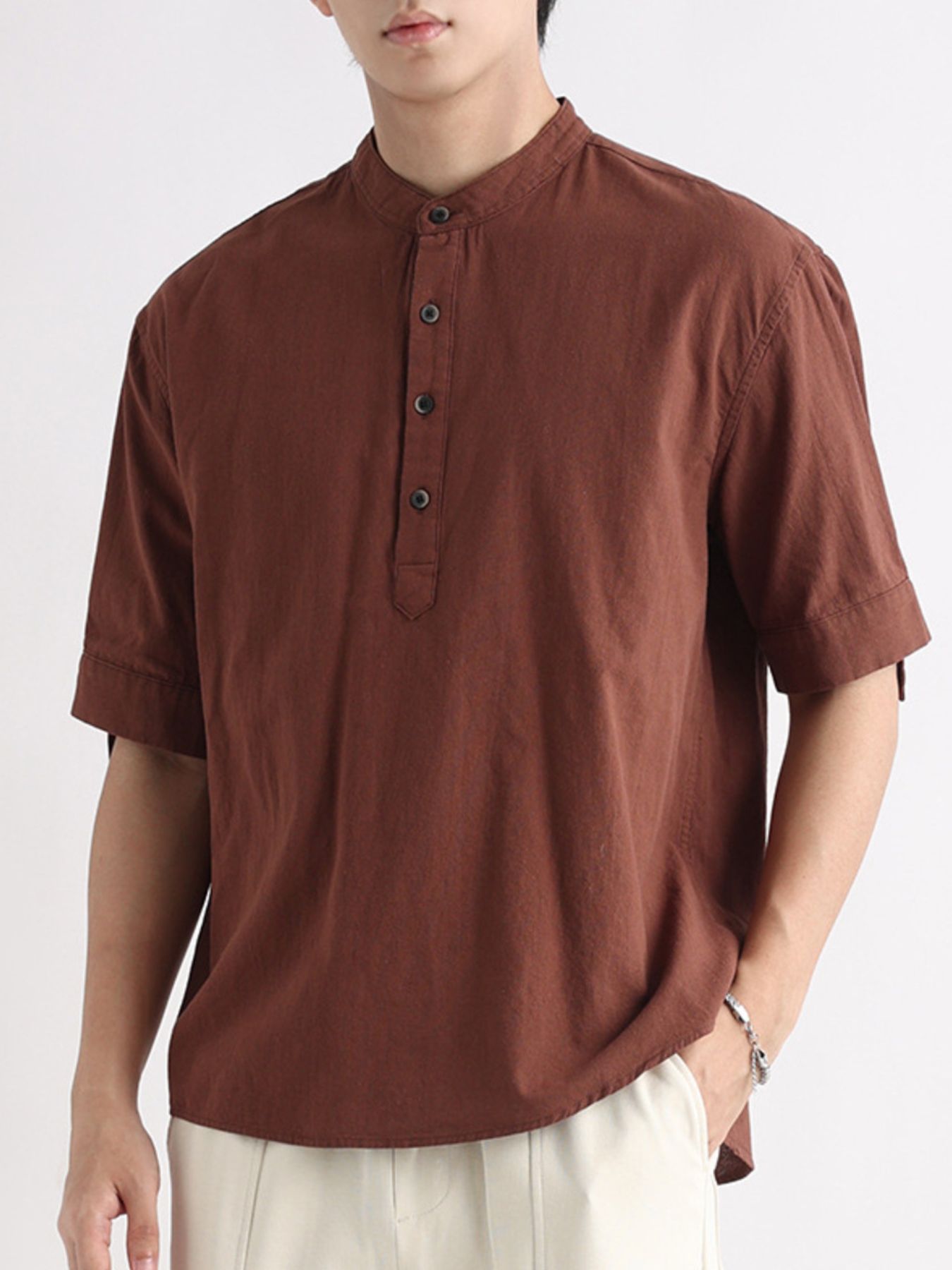 Brown band collar button-down short sleeve blouse with a casual fit.
