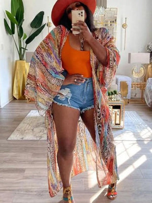 Vibrant bohemian print open-front long cardigan with wide sleeves and abstract patterns.