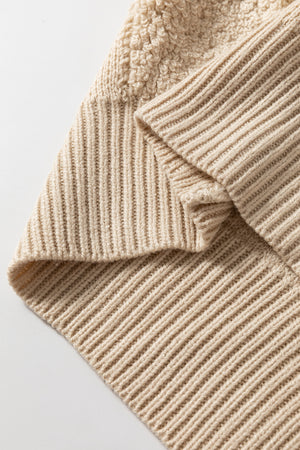 Beige acrylic knit sweater with textured checkerboard detail and ribbed trim.