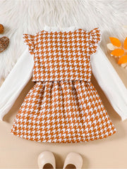 Toddler houndstooth vest and skirt set with white ribbed long sleeve shirt and ruffled sleeves.
