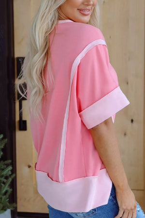 Pink polyester t-shirt with contrast seam detail and banded cuffs.