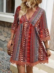 Bohemian printed red v-neck dress with bell sleeves and lace trim.