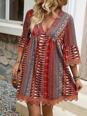 Bohemian printed red v-neck dress with bell sleeves and lace trim.