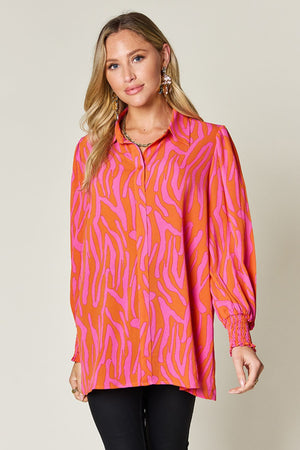 Orange and pink zebra print blouse with shirred cuffs and a collared neckline.