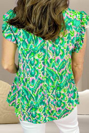 Green abstract print cap-sleeve blouse with ruffle details.