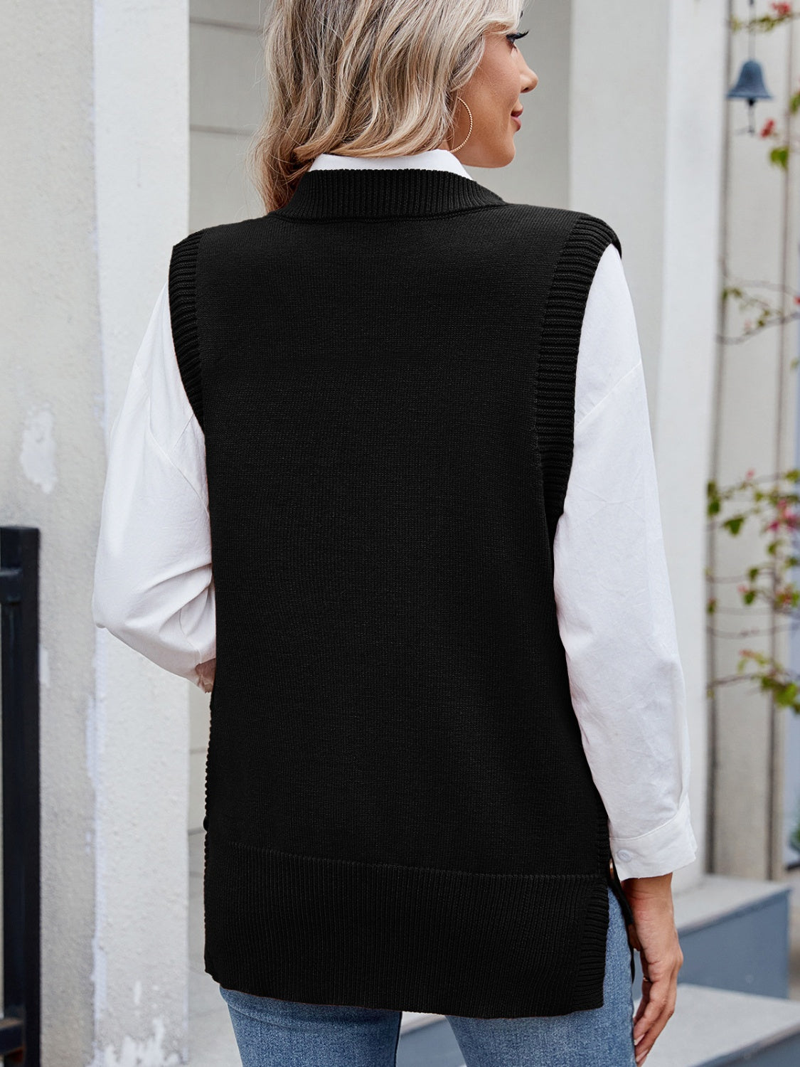 Black ribbed knit vest with side buttons, collared neckline, and a relaxed fit.