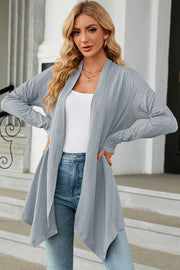 Light blue textured knit cardigan with asymmetrical drape front and long sleeves.