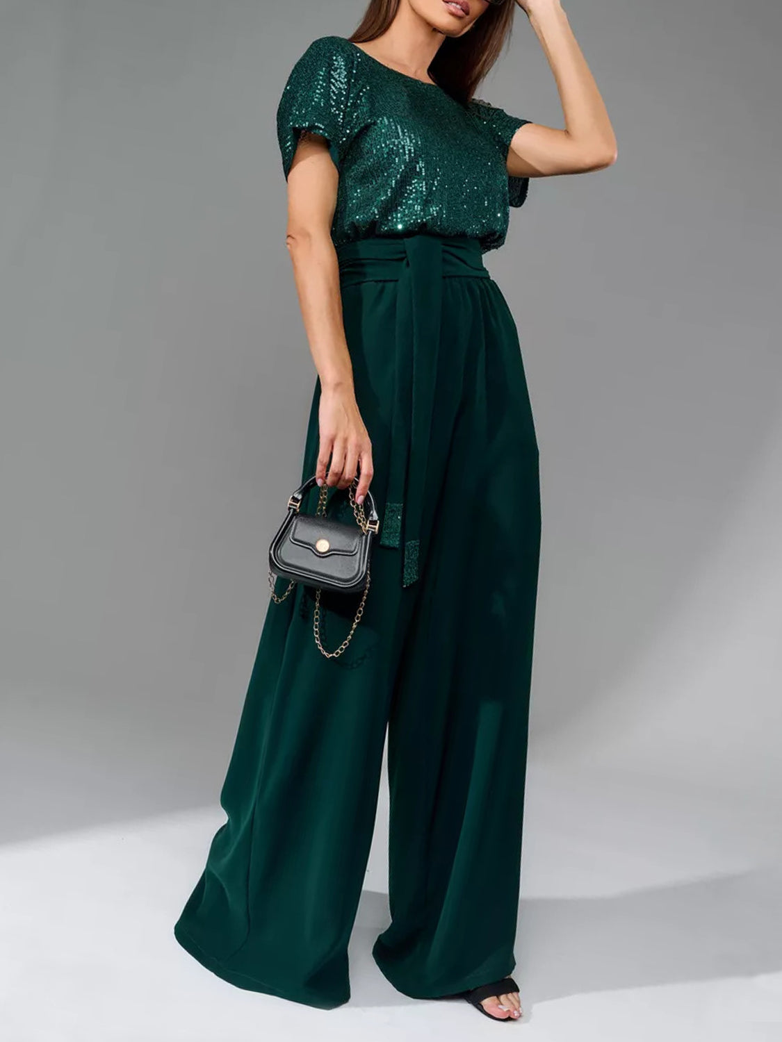 Dark green sequin bodice and palazzo pant suit with belted waist.