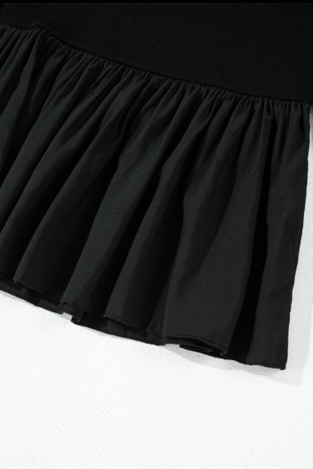 Black ribbed bodice peplum top with ruffled hem detail
