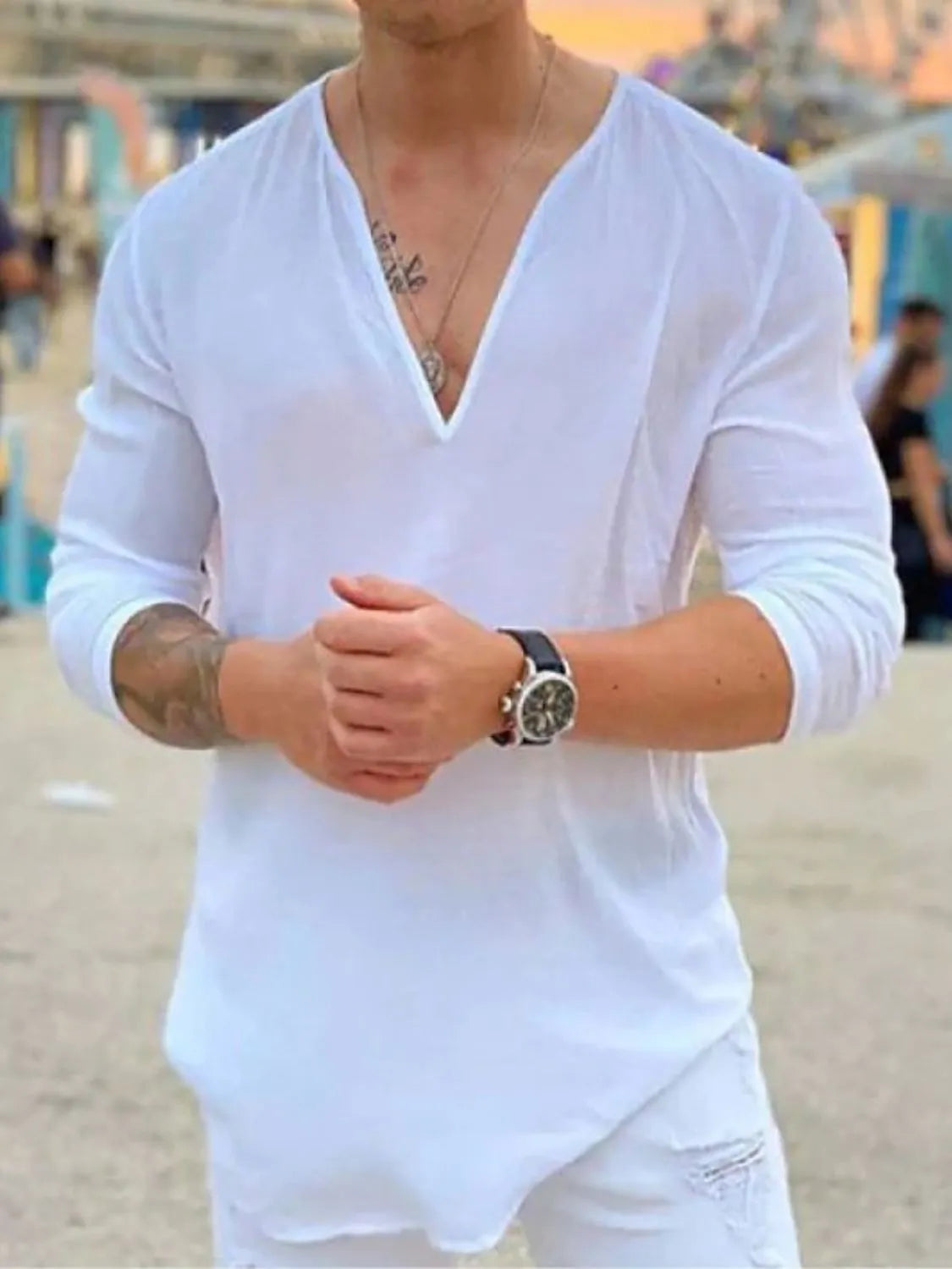 White linen relaxed fit top with deep V-neck and long sleeves.
