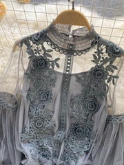 Gray lace blouse with floral embroidery and sheer sleeves.