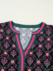 Black floral print cotton blouse with contrast green and pink trim at the V-neck.