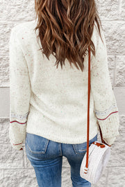 White speckled knit sweater with contrast cuff detail and crew neck.