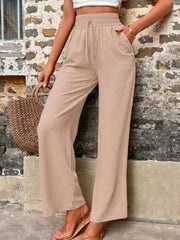 Drawstring linen palazzo trousers in khaki with wide legs and button pocket detail.
