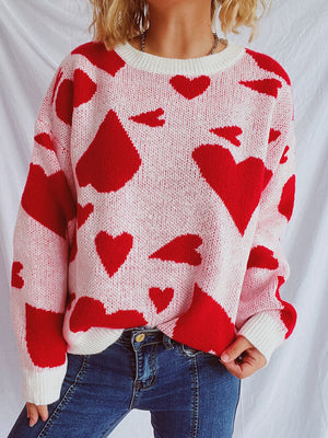 Heart motif knit sweater in pink with red hearts, crewneck, long sleeves, casual style.