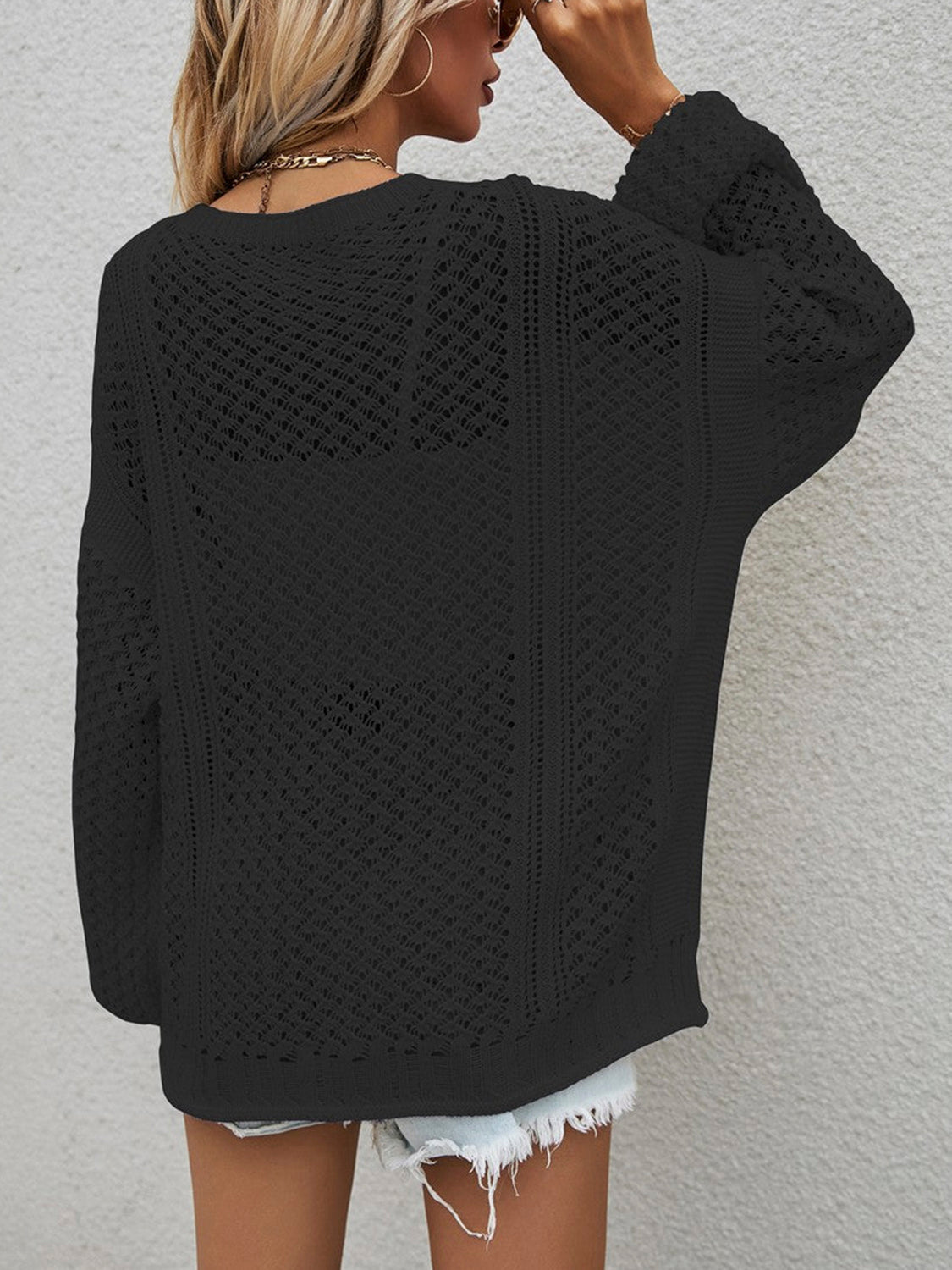 Black open-knit acrylic cardigan with balloon sleeves and a relaxed fit.