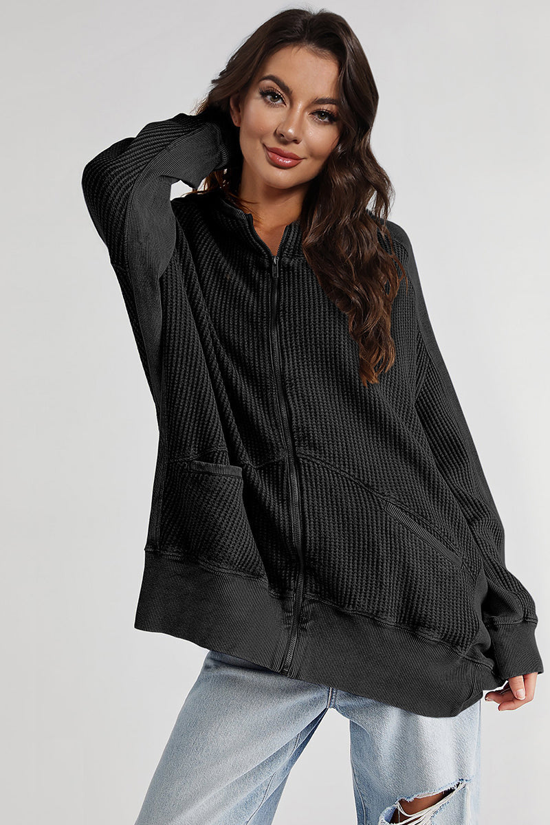 Black waffle knit zip-through hoodie with front pockets and ribbed cuffs and hem.