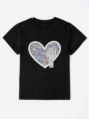 Black t-shirt with iridescent heart and cross appliqué detail.