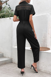 Black lace yoke button-down jumpsuit with wide legs and elastic waist.