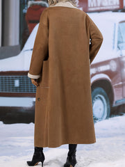 Brown reversible maxi coat with shearling trim and side pockets.