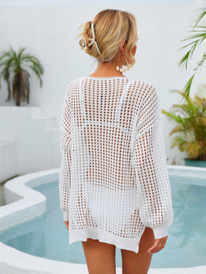 White open knit beach cover-up with star embellishments and long sleeves.