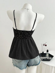 Black polka dot peplum cami with spaghetti straps and smocked bodice.