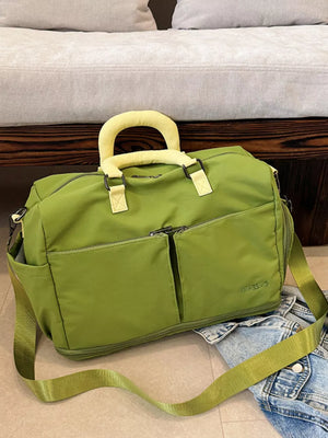 Green travel organizer bag with multiple pockets and adjustable strap.