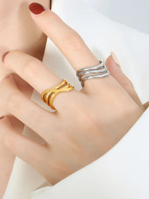 Gold and silver triple-band sculptural rings shown on fingers