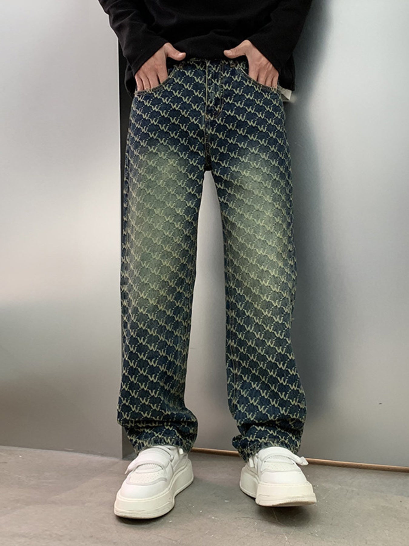 Men's relaxed fit jeans in dark wash denim with all-over woven motif pattern and distressed details.