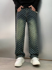 Men's relaxed fit jeans in dark wash denim with all-over woven motif pattern and distressed details.
