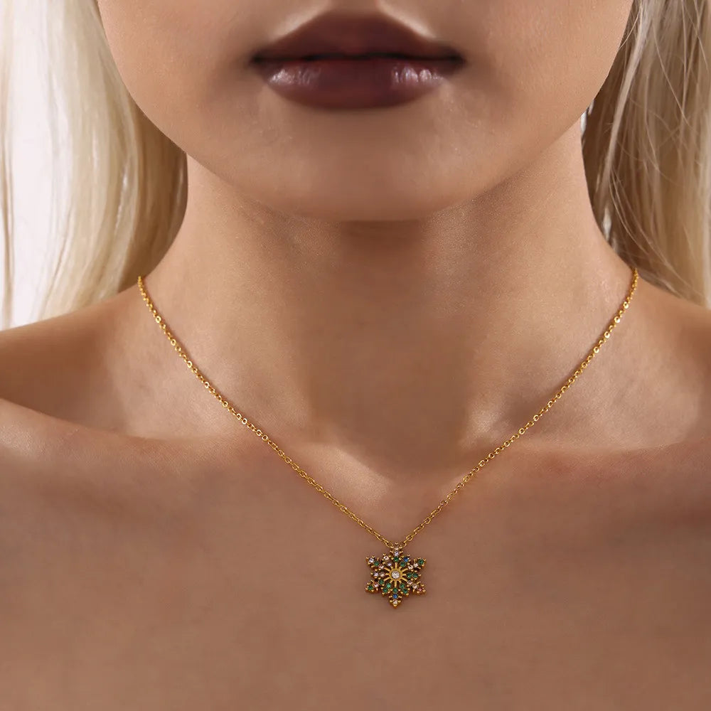 Celestial Snowflake Pendant Necklace with mixed color stones on a gold chain.