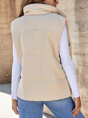 Ribbed corduroy zip-up vest coat in off-white with a high collar, worn over a white long-sleeve shirt.