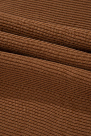Brown ribbed knit pullover sweater with balloon sleeves.