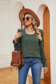 Textured green knit blouse with square neckline and ruffled cuffs.