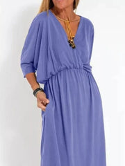 Light purple V-neck maxi dress with dolman sleeves, cinched waist, and side pockets.