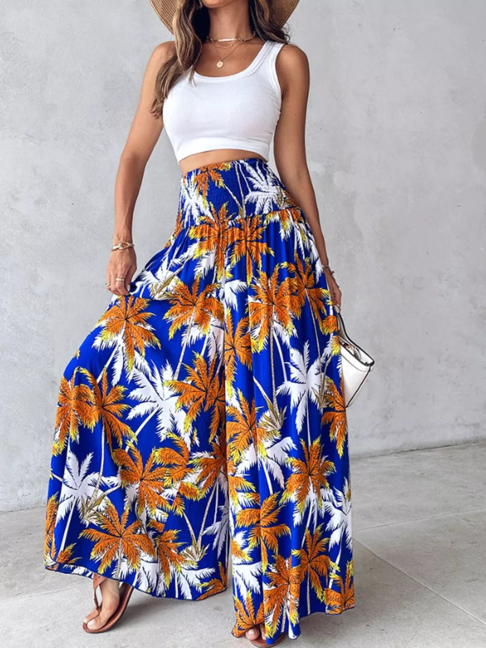 Bohemian print smocked waist wide-leg pants in royal blue with palm trees.